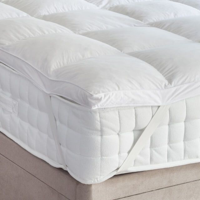 King bed topper styled under bedsheets