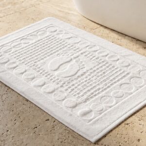 White textured bath mat with decorative footprint design